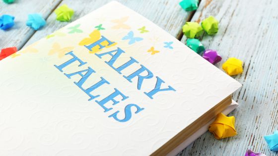 A book on a table with the title "Fairy tales" surrounded by colourful paper stars.