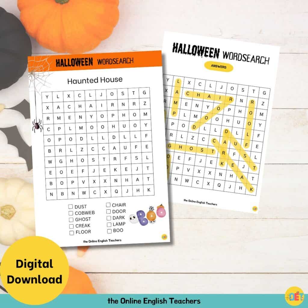 Image shows a flat lay halloween decorated table with a children's halloween wordsearch on top about a haunted house.
