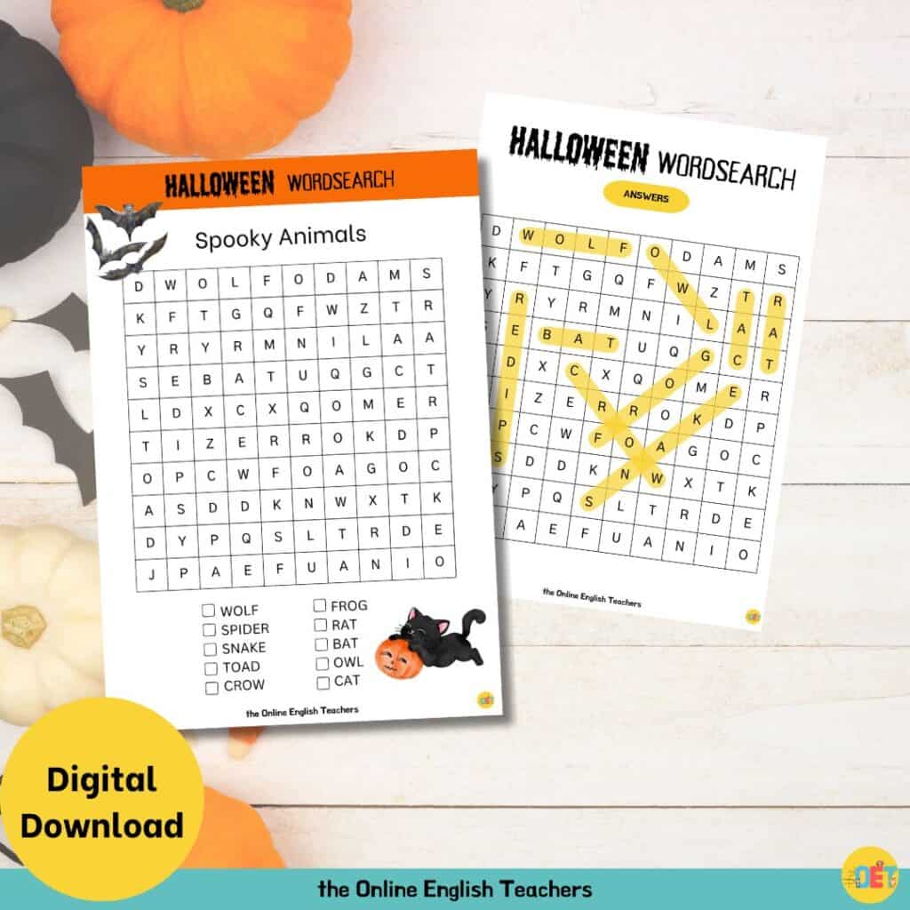 Image shows a flat lay halloween decorated table with a children's halloween wordsearch on top about spooky animals.