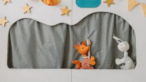 a puppet show with a fox and rabbit fabric puppet