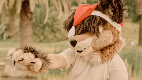 a child dressed in a lion suit acting