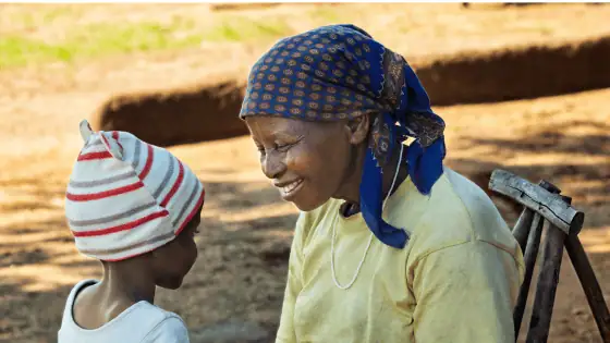 a woman and child smiling and talking together