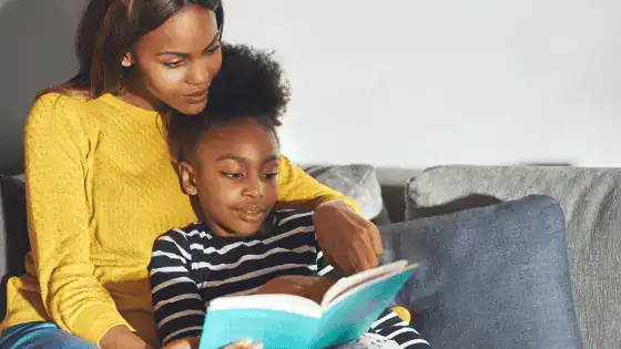 mother and son reading a book together image